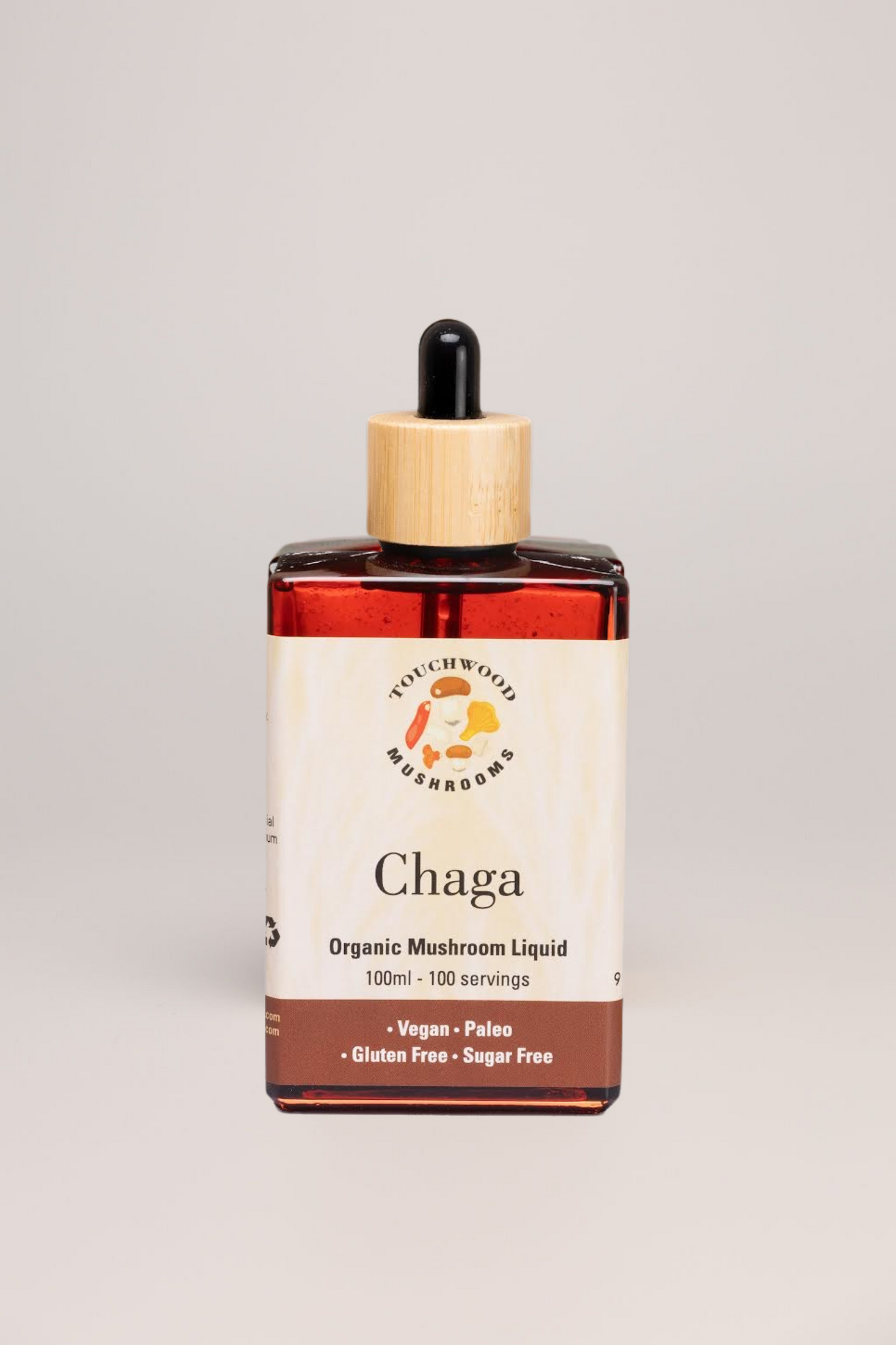 Bottle of Chaga organic mushroom liquid with a dropper on a light grey background