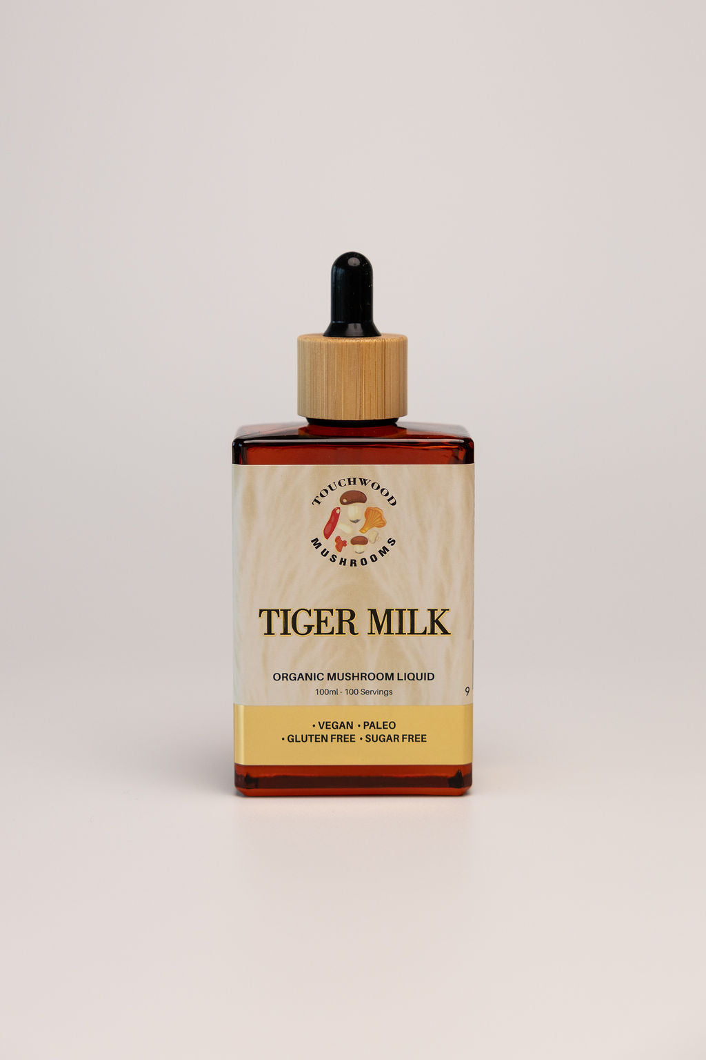 Bottle of Tiger Milk mushroom liquid on a light grey background