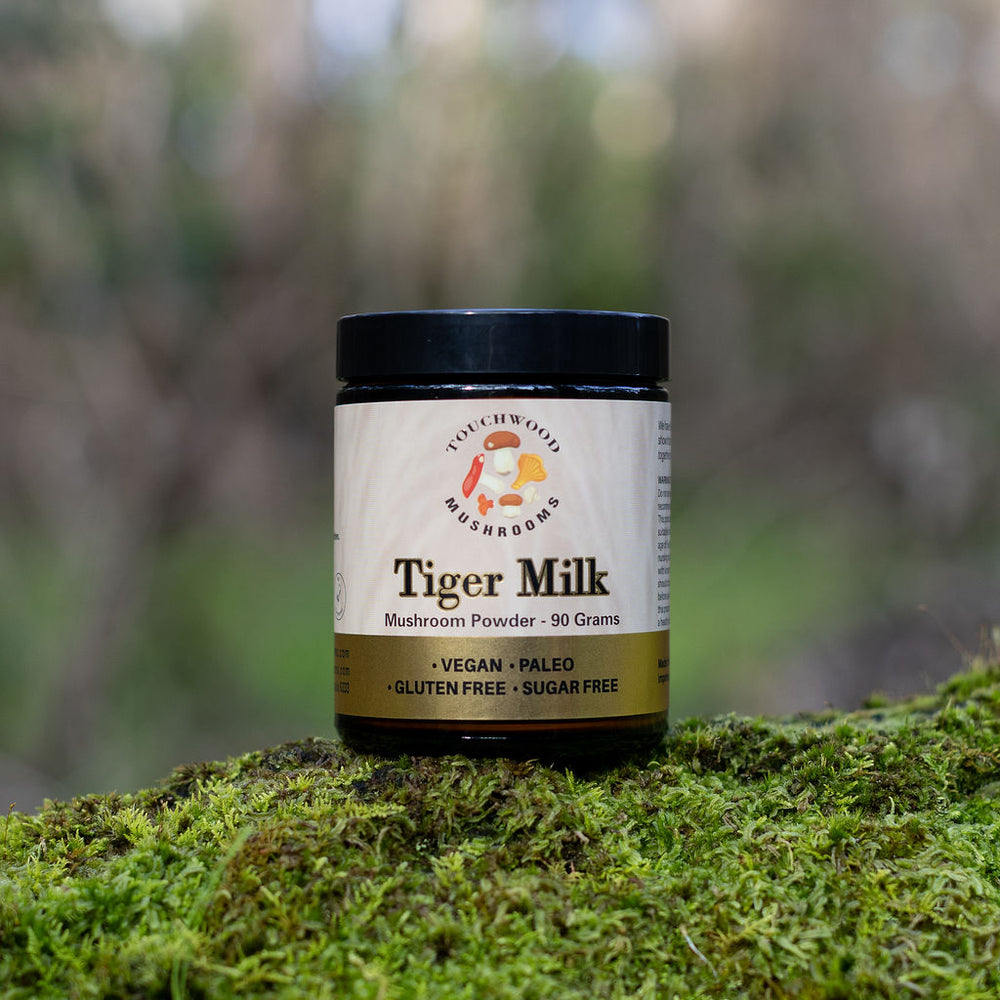 Jar of Tiger Milk on a mossy surface with a blurred natural background