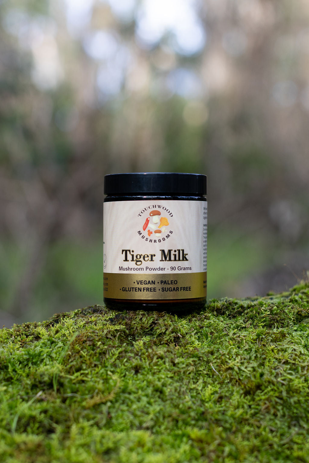 Jar of Tiger Milk on a mossy surface with a blurred natural background