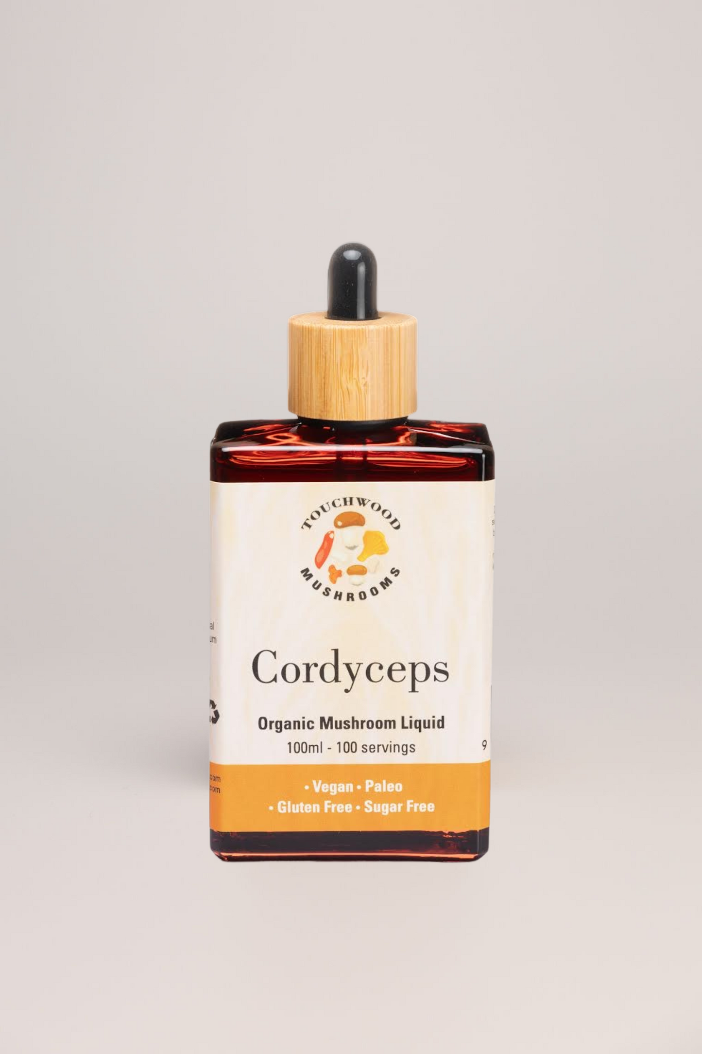 Bottle of Cordyceps organic mushroom liquid with a dropper on a gray background
